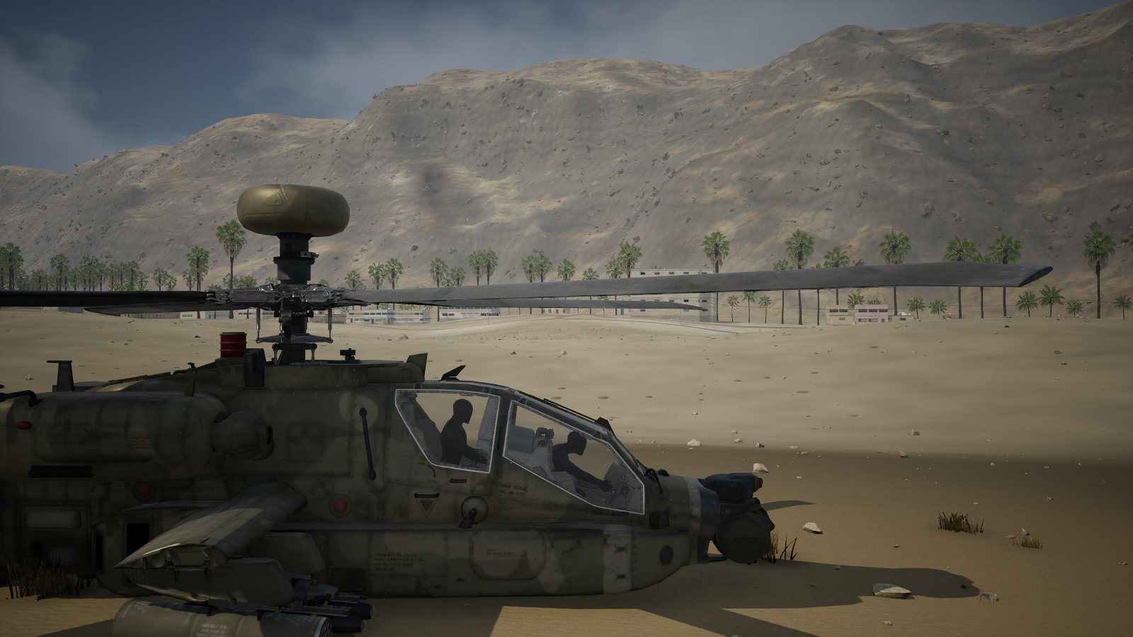 A parked Apache seen from the side on the sand at Khasab, two crew seated under the tandem canopies.