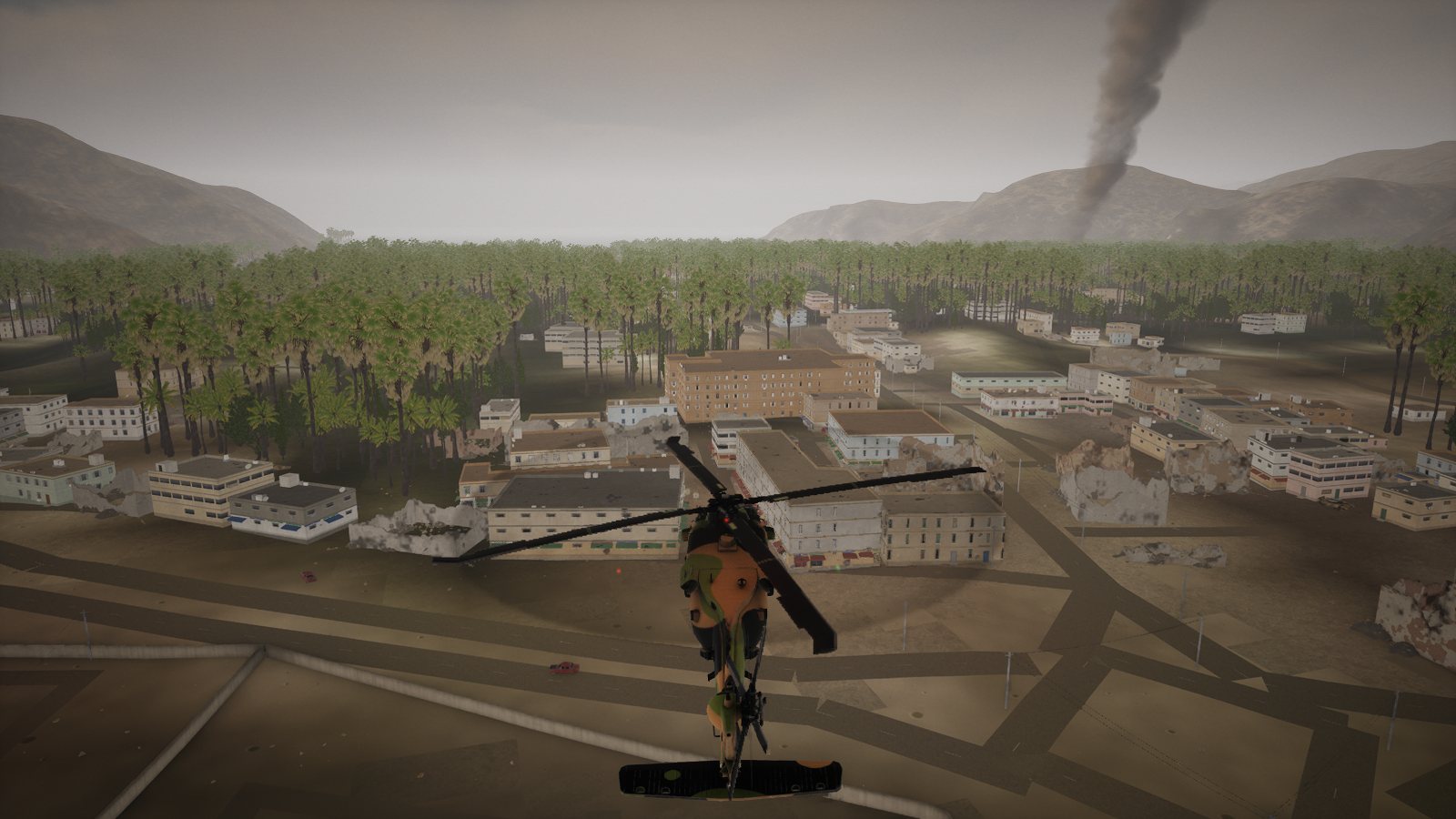 A UH-60 Black Hawk in desert camouflage seen from behind, flying over the rooftops of Khasab toward the palm groves.